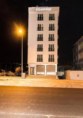a white building with a street light in front of it at Fidanoğlu Suite Hotel Çorlu in Corlu