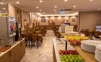 a restaurant with plates and fruits on the counter at Hamitbey Hotel Yenikapı in Istanbul