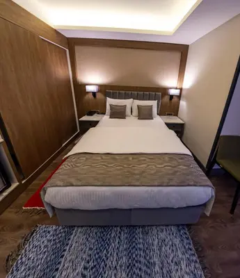 a bedroom with a large bed and two night stands at Hamitbey Hotel Yenikapı in Istanbul