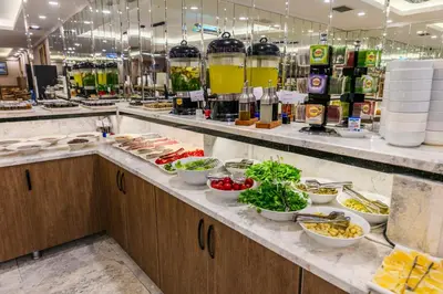 a buffet line with bowls of food and drinks at Hamitbey Hotel Yenikapı in Istanbul
