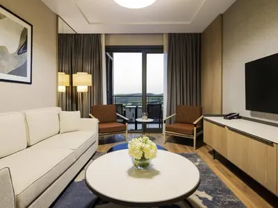 a living room with a couch and a tv at Movenpick Living Istanbul Camlivadi in Istanbul