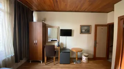a room with a desk and a table and a mirror at Herton Boutique Hotel in Istanbul