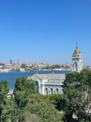 a building with a dome on top of it next to the water at Fatih Balat tarihin içinde şık bir ev 2 in Istanbul