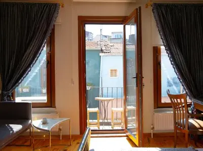 a living room with a couch and a large window at Fatih Balat tarihin içinde şık bir ev 2 in Istanbul