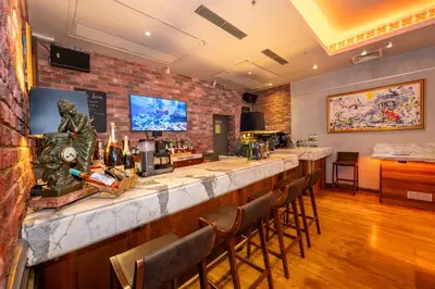 a bar in a restaurant with a brick wall at Pera Tulip Hotel & Spa in Istanbul