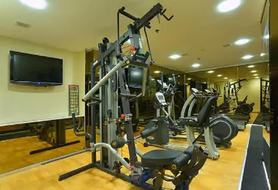 a gym with tread machines and a flat screen tv at Pera Tulip Hotel & Spa in Istanbul
