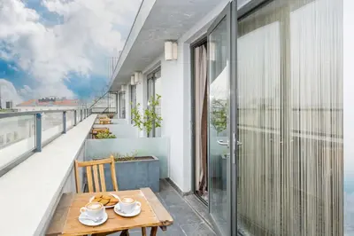a balcony with a wooden table and a view of the ocean at Pera Tulip Hotel & Spa in Istanbul