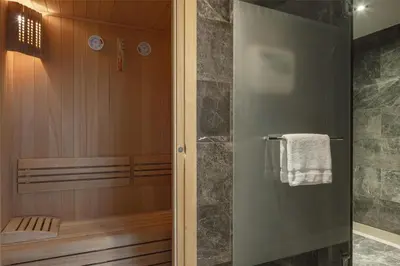 a bathroom with a shower with a glass door at Conrad Istanbul Bosphorus in Istanbul