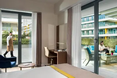 a hotel room with a bed and a view of a courtyard at The Superior Living Batışehir in Istanbul