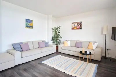 a living room with two white couches and a rug at A Million Dollar View In the Heart of the City in Istanbul