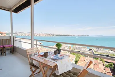 a balcony with a table and chairs and the ocean at A Million Dollar View In the Heart of the City in Istanbul