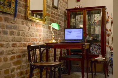 a room with a desk with a laptop computer on it at Çırağan's Omnia Hotel in Istanbul