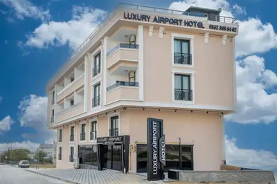 a white building with a sign in front of it at Luxury Airport Hotel By Zazzoni-İstanbul Airport in Arnavutköy