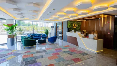 a lobby with a woman sitting at a desk at Luxury Airport Hotel By Zazzoni-İstanbul Airport in Arnavutköy
