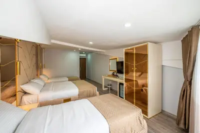a hotel room with two beds and a desk at Luxury Airport Hotel By Zazzoni-İstanbul Airport in Arnavutköy