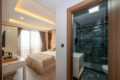 a hotel room with a bed and a bathroom at Luxury Airport Hotel By Zazzoni-İstanbul Airport in Arnavutköy