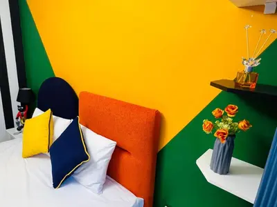 a colorful bedroom with a bed with a vase of flowers at Apex Hotel in Istanbul