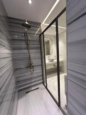 a bathroom with a shower with a sink and a mirror at Grand Yavuz Hotel Sultanahmet in Istanbul