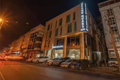 a group of cars parked in front of a building at Grand Quars Hotel in Avcılar