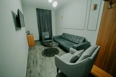 a living room with a couch and a chair at Grand Quars Hotel in Avcılar