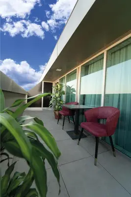 a balcony with chairs and a table on a building at Grand Quars Hotel in Avcılar