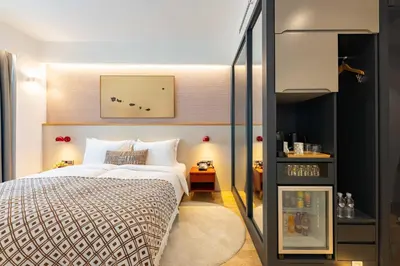 a bedroom with a large bed and a table at Pınar Otel in Erdek
