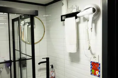 a bathroom with a hairdryer and a phone on a wall at LakeviewhouseSapanca in Sapanca