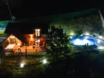 a small house with a swimming pool at night at LakeviewhouseSapanca in Sapanca