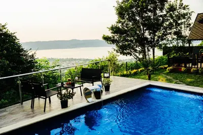 a swimming pool with a table and chairs on a balcony at LakeviewhouseSapanca in Sapanca