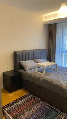 a bedroom with a bed with a table on it at Cebeci Residence Pendik in Istanbul