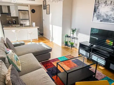 a living room with a couch and a flat screen tv at Cebeci Residence Pendik in Istanbul