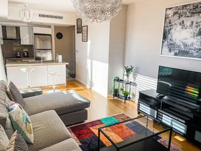 a living room with a couch and a tv at Cebeci Residence Pendik in Istanbul