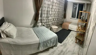 a small bedroom with a bed and a window at Ahmet Teacher's villa is 6 minutes from Istanbul airport in Arnavutköy