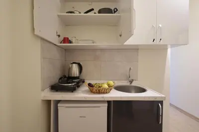 a kitchen with a sink and a bowl of fruit at Bonita Apart in Istanbul