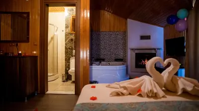 two swans sitting on a bed in a bathroom at DEFNE OTEL in Sile