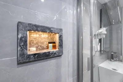 a bathroom with a shower and a sink and a mirror at Azalea Mansion Oldcity in Istanbul