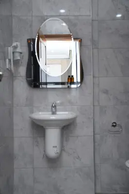 a bathroom with a sink and a mirror at Hotel Arinna in Istanbul