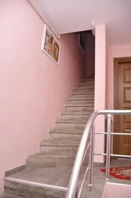 a staircase in a house with a pink wall at Hotel Arinna in Istanbul