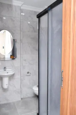 a bathroom with a shower and a toilet and a sink at Hotel Arinna in Istanbul