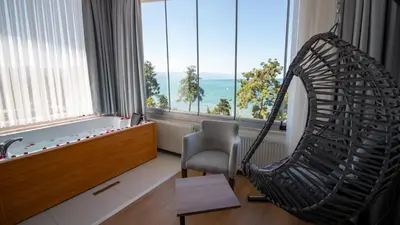 a room with a hammock and a chair in front of a window at Lake Life Hotel in İznik