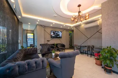 a living room with couches and a table and chairs at Comfort Point in Istanbul