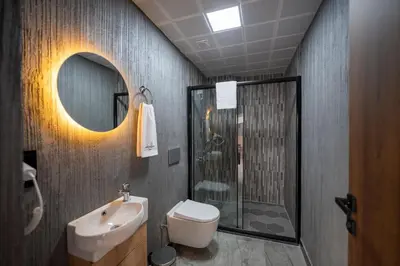 a bathroom with a toilet and a sink and a shower at Comfort Point in Istanbul