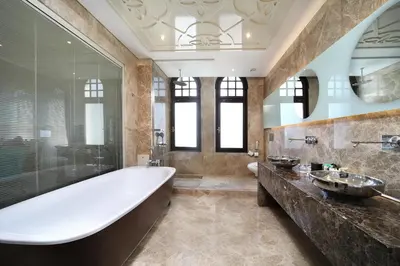 a bathroom with a large tub and a sink at Legacy Ottoman Hotel Istanbul Old City in Istanbul