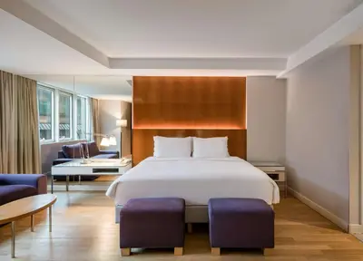 a bedroom with a large bed and a living room at Radisson Blu Bosphorus Hotel in Istanbul