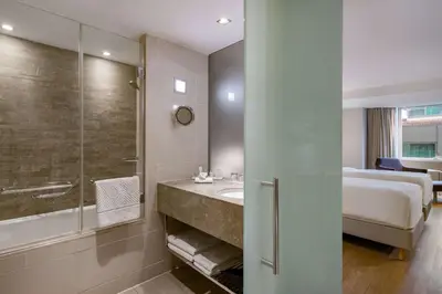 a bathroom with a sink and a shower and a bed at Radisson Blu Bosphorus Hotel in Istanbul
