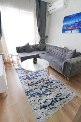 a living room with a couch and a table at Classic Suite BH13 in Esenyurt