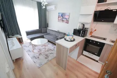 a small living room with a couch and a kitchen at Classic Suite SH17 in Esenyurt