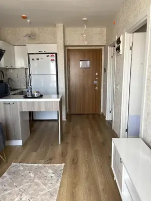 a kitchen with a white counter and a refrigerator at Classic Suite SH17 in Esenyurt