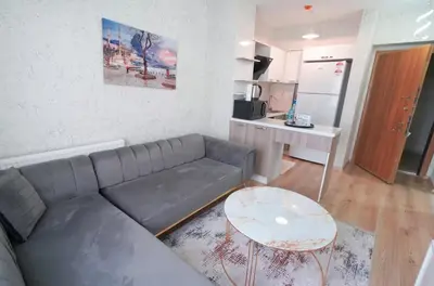 a living room with a couch and a table at Classic Suite SH17 in Esenyurt