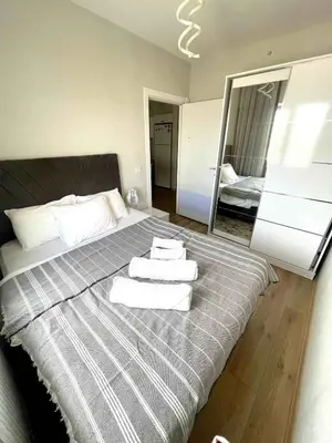 a bedroom with a large bed with towels on it at Classic Suite SH17 in Esenyurt